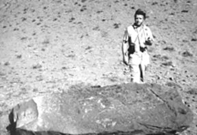 Ron Wyatt in 1977 by a large stone with crosses carved on it and a hole broken away from one end.