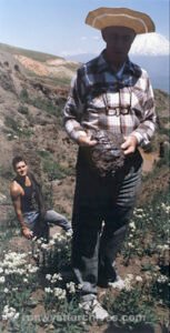 Dr. Nathan Meyer holding the large chunk of ballast material he had just picked up.