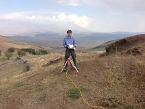 John Larsen is running the cable for 1 vertical scan. He places an electrode at predetermined intervals and records GPS location, altitude, and other pertinent information to coordinate with all the other scans for 3D rendering.