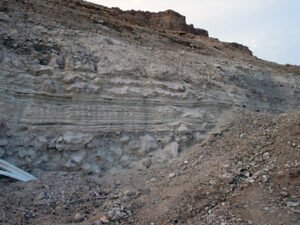 This shows the remains extend all the way to the bedrock. Notice the rocks under the lowest level of layers (mid screen) (© Mary Nell Lee)